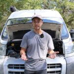 Chris explaining car overheating with no leaks beside his van with the hood open
