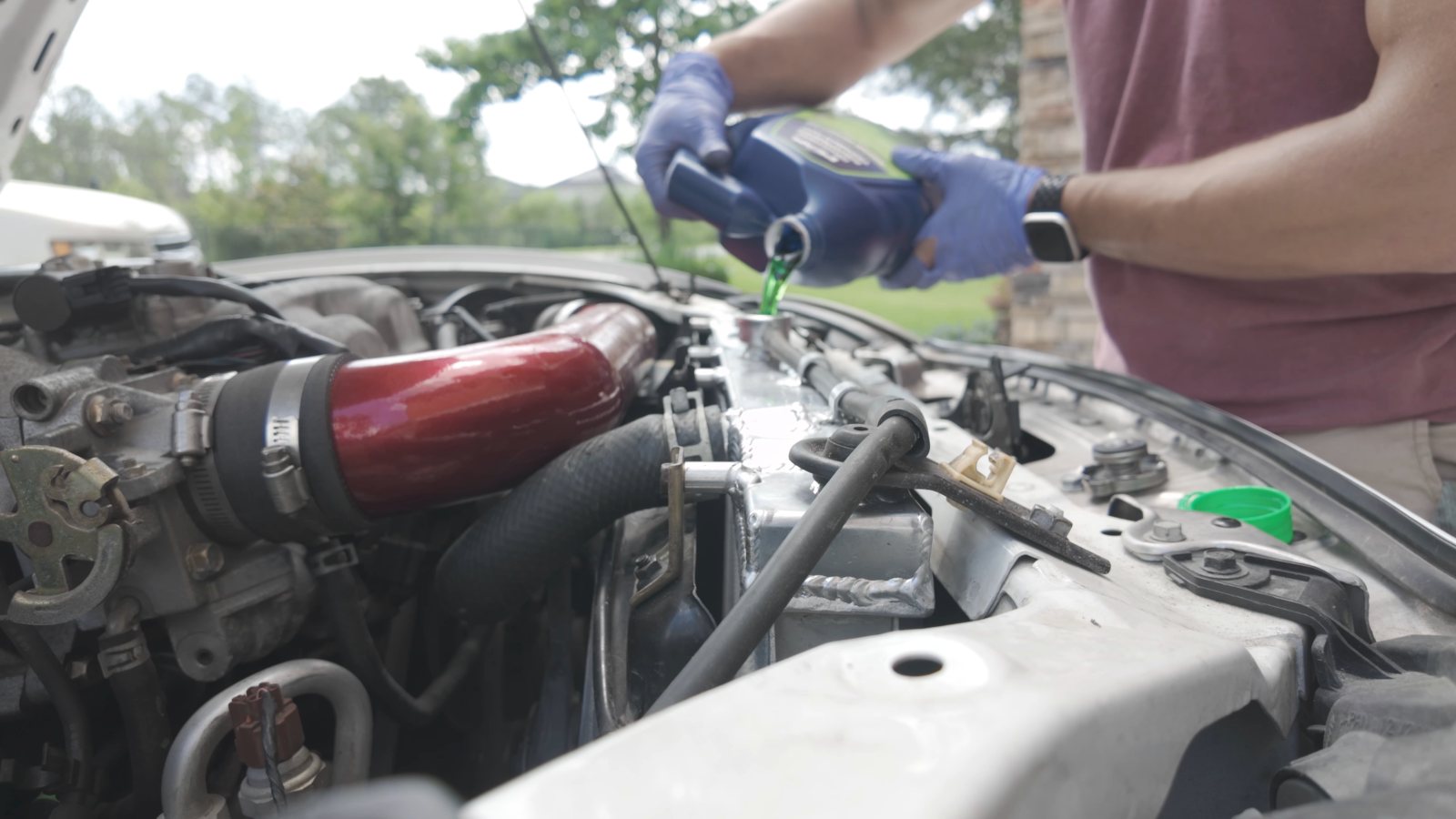 Chris adding coolant during cooling-system service